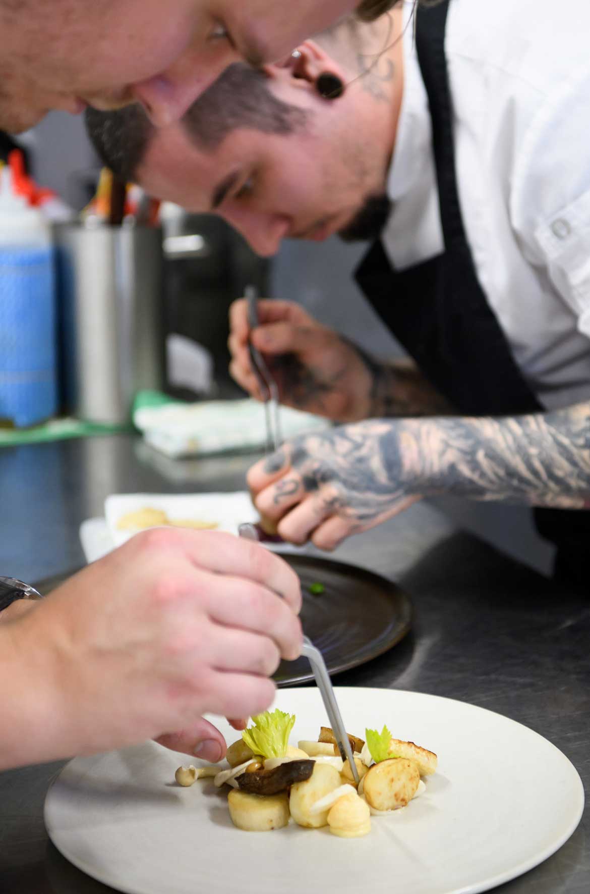 GOMA Restaurant chefs Matthew Blackwell and Michael Bickford developing plating design for one of the new spring menu dishes, Noosa Earth mushroom, celeriac, raw milk fontina, prune.